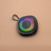 Black portable speaker with a colorful ring-shaped light effect on the front and Bluetooth wireless mini speaker details Picture